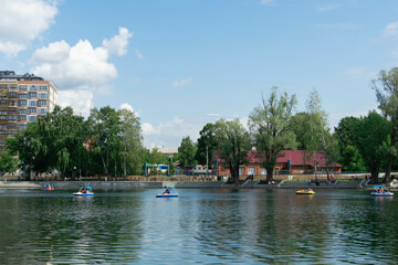 summer vacation in the park by the lake, riding on catamarans
