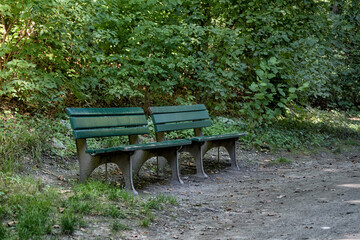 Two wooden old benches in the autumn park.