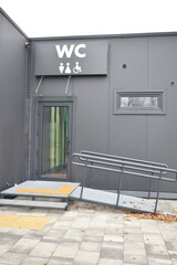 public toilet with steps and pantus for people with disabilities