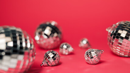 Creative Christmas composition with shiny disco balls bauble on vivid pink background. Minimal Xmas or New Year celebration concept. Elegant holidays party banner.
