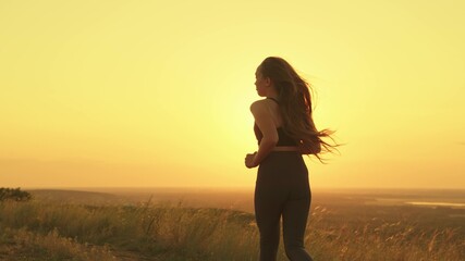 Fototapeta na wymiar girl jogging at sunset sky, active lifestyle rays sun, cardio training nature, running man bright light, monitor health and body shape, activate the body metabolism with physical exercise exercises