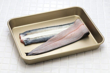 Preparing Japanese Unagi(eel) dishes; Slit open the eel along the back and cut off the head.