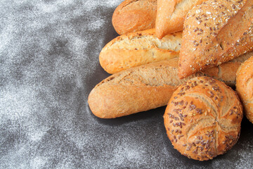 fresh bread, baguette and buns with seeds and spices.