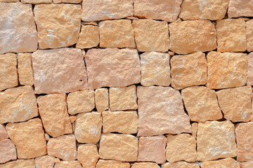 Masonry wall of stones with irregular pattern texture background