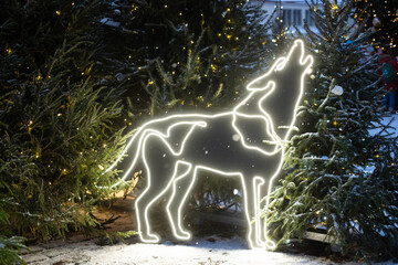Large light animal sculpture decoration and Christmas trees. Led light holiday decorations on public city street.