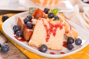 Lemon pund cake with blueberries and strawberry syrup.