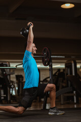 personal trainer performing a crossfit workout at gym