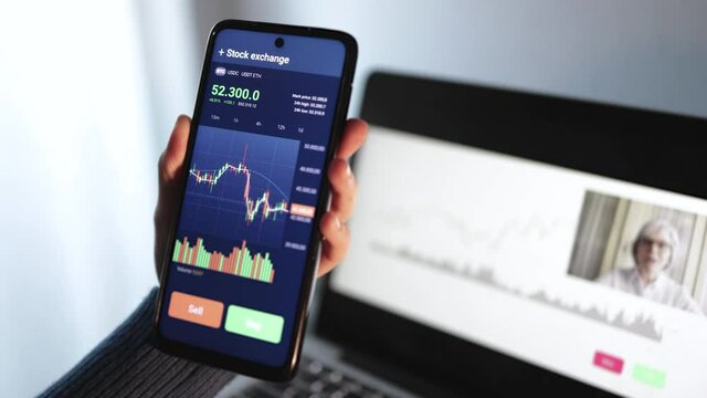 Trader stream online financial education class with senior coach using mobile phone - Forex trading concept