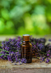 Obraz na płótnie Canvas Lavender essential oil in a bottle. Selective focus.
