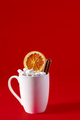 Christmas mug with marshmallows on a red background.
