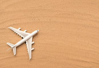 Passenger white plane on the sand. Advertising transportation concept.
