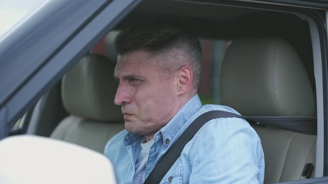 Anxious man driver feeling cramps and unbearable abdominal pain, stomach bug