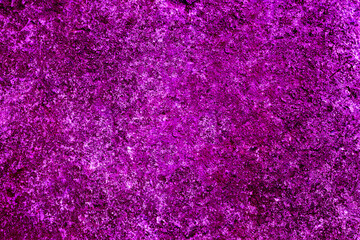 Rocky texture of rough surface terrain contrast violet colored. Abstract grunge fuchsia background