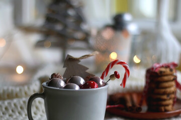Various Christmas ornaments, candles and colorful bokeh lights. Selective focus.