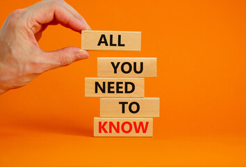 All you need to know symbol. Wooden blocks with words All you need to know on beautiful orange background, copy space. Businessman hand. Business, all you need to know concept.