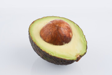 Half cut haas avocado with seed isolated on white background, flat lay clipping path