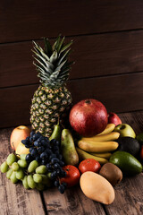 Mix of fresh juicy colorful exotic tropical fruits on wooden background