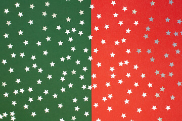 Red and green Christmas background with scattered silver stars.