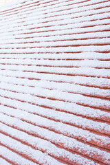 Pitched roof covered in snow in winter, UK