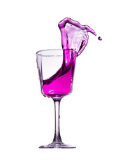 A splash of pink liquid in a glass glass isolated on a white background.