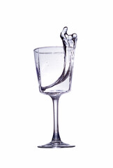A splash of clear liquid in a glass glass isolated on a white background.