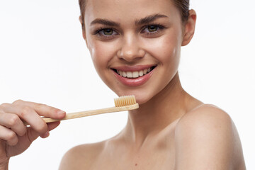 cheerful woman with bare shoulders toothbrushes hygiene oral care