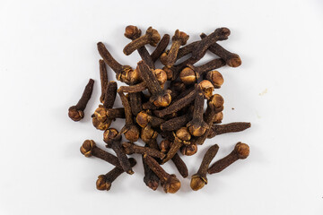 Pile of organic fresh whole clove buds , scattered clove buds isolated on white background. close up.top view.