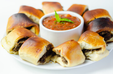 Patty's pies stuffed with minced meat, mushrooms and onion, served with sauce