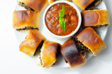 Patty's pies stuffed with minced meat, mushrooms and onion, served with sauce