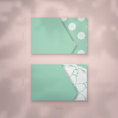 Business card in mint color with indian white ornaments for your brand.