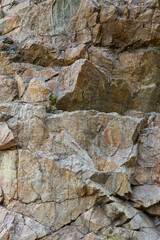 Destruction of the rock of the mountain after the explosion. Cracks in the granite rock due to human activity. Concept of environmental problems