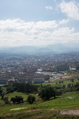 Beautiful aerial view of Oviedo. Green fields and mountains around the city. Sunny day, no people. Asturias