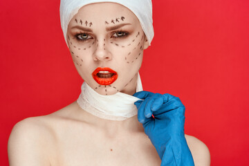 beautiful woman posing in blue gloves red lips surgery facial rejuvenation studio lifestyle