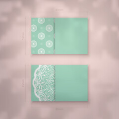 Business card template in mint color with Greek white ornaments for your business.