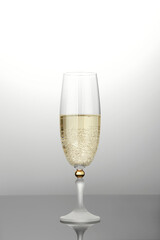 Glass with champagne on a gray background.