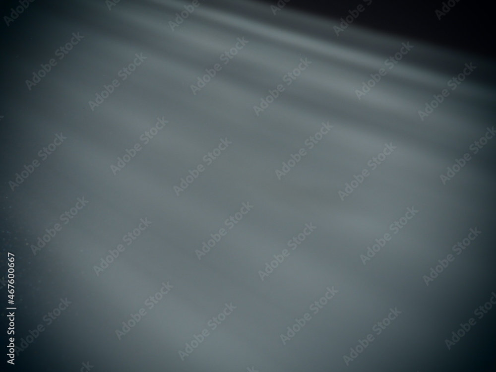Poster diagonal rays of light on a gray background. blurred abstract background light effect, light leaks. 