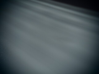 Diagonal rays of light on a gray background. Blurred abstract background light effect, light leaks....
