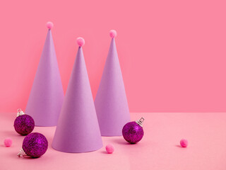 New Year's card. Christmas tree made of paper, Christmas balls on a pink background. symbol of the new year