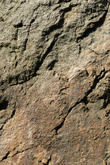 Texture of granite rock. Cracked stone surface from weathering. Close up of granite surface. Earth color concept