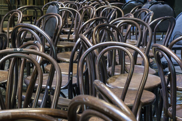 A row of wooden brown vintage chairs