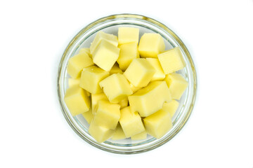 Fototapeta na wymiar Cheese cubes in bowl isolated on white background top view