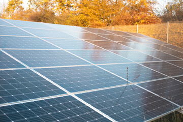 Ecology electric energy farm. Solar panels in autumn landscape. Alternative energy.