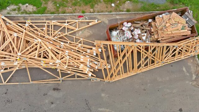 27 AUGUST 2021 Woodbridge NJ USA: Construction trash garbage dumpsters on metal container house renovation on stacker wooden material boards and beams