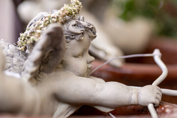 Figurine of amor aiming with bow and arrow - Powered by Adobe