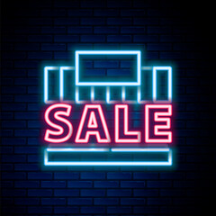 Obraz premium Glowing neon line Shopping building or market store icon isolated on brick wall background. Supermarket sale concept. Colorful outline concept. Vector