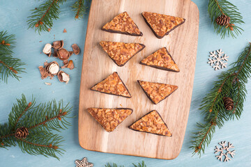 Nut corner, traditional german sweets called Nussecke, covered with chocolate, christmas baking