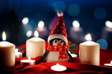 Winter Christmas holidays background with candles, christmas light, toy near a window