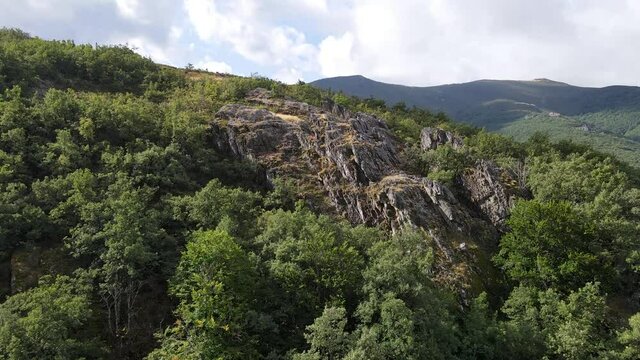 Large rocks and tall trees in the mountains seen from a drone. Somosierra Madrid.