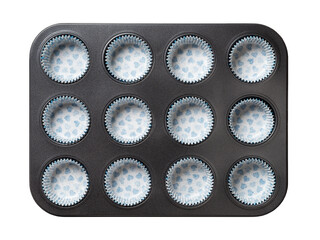 Muffin cake pan with paper baking cups isolated on a white background. Empty 12-cup muffin non-stick baking tray with paper corrugated molds. Baking dish for cupcake and pastries. Kitchen utensils.