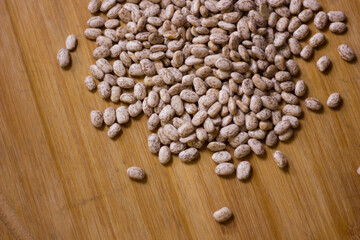Beans on a wooden background.